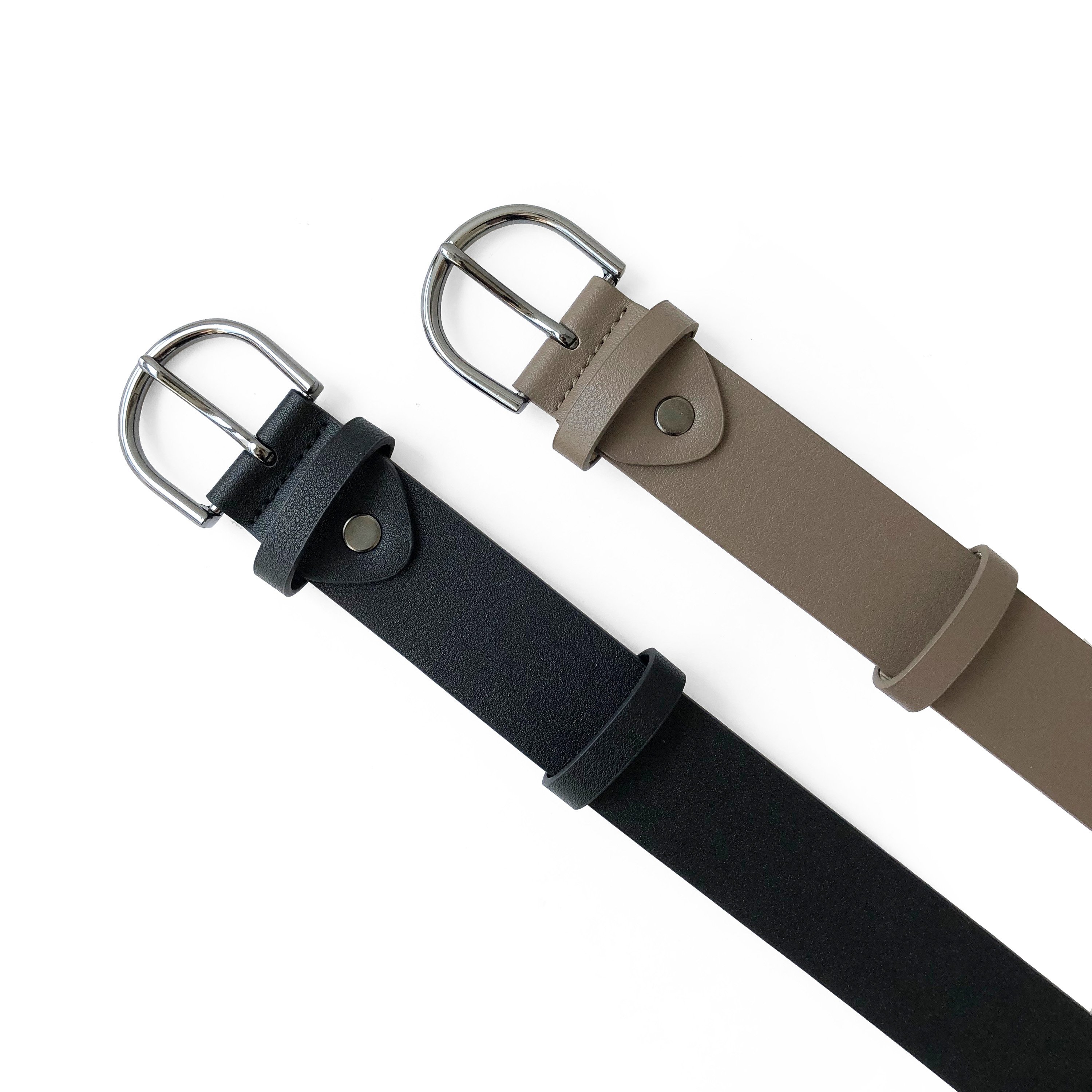 Ladies belt featuring a rounded gunmetal buckle on a matte finish synthetic leather strap, showcasing elegance and style.