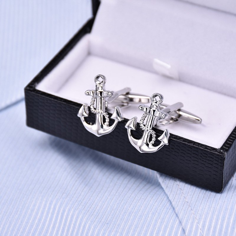 A pair of elegant anchor cufflinks made from titanium alloy, featuring a polished surface finish, displayed in a hard-sided presentation box.