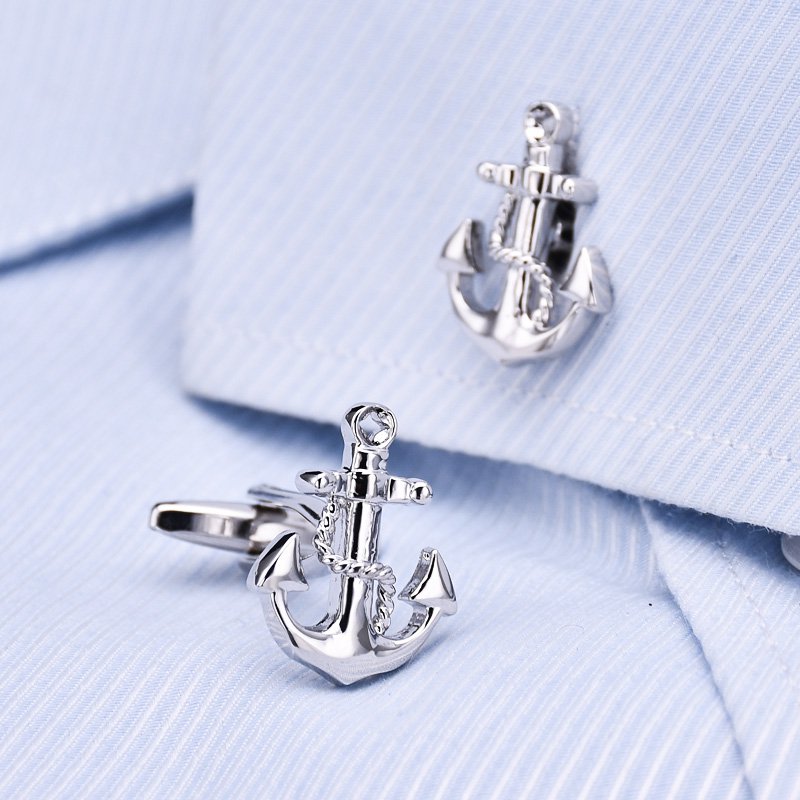 A pair of elegant anchor cufflinks made from titanium alloy, featuring a polished surface finish, displayed in a hard-sided presentation box.