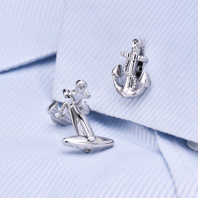 A pair of elegant anchor cufflinks made from titanium alloy, featuring a polished surface finish, displayed in a hard-sided presentation box.