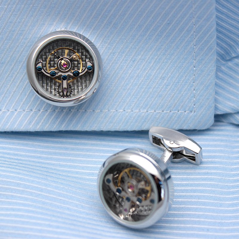 A pair of Automatic Watch Engine Cufflinks made from titanium, showcasing intricate watch mechanics, presented in an elegant gift box.