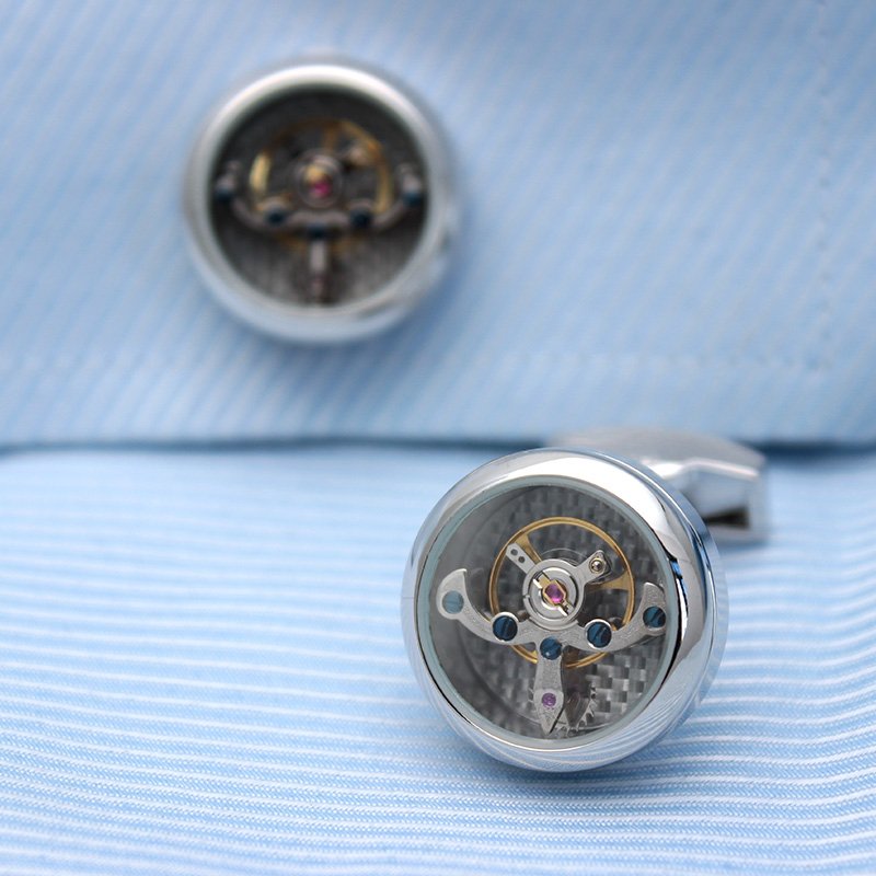 A pair of Automatic Watch Engine Cufflinks made from titanium, showcasing intricate watch mechanics, presented in an elegant gift box.