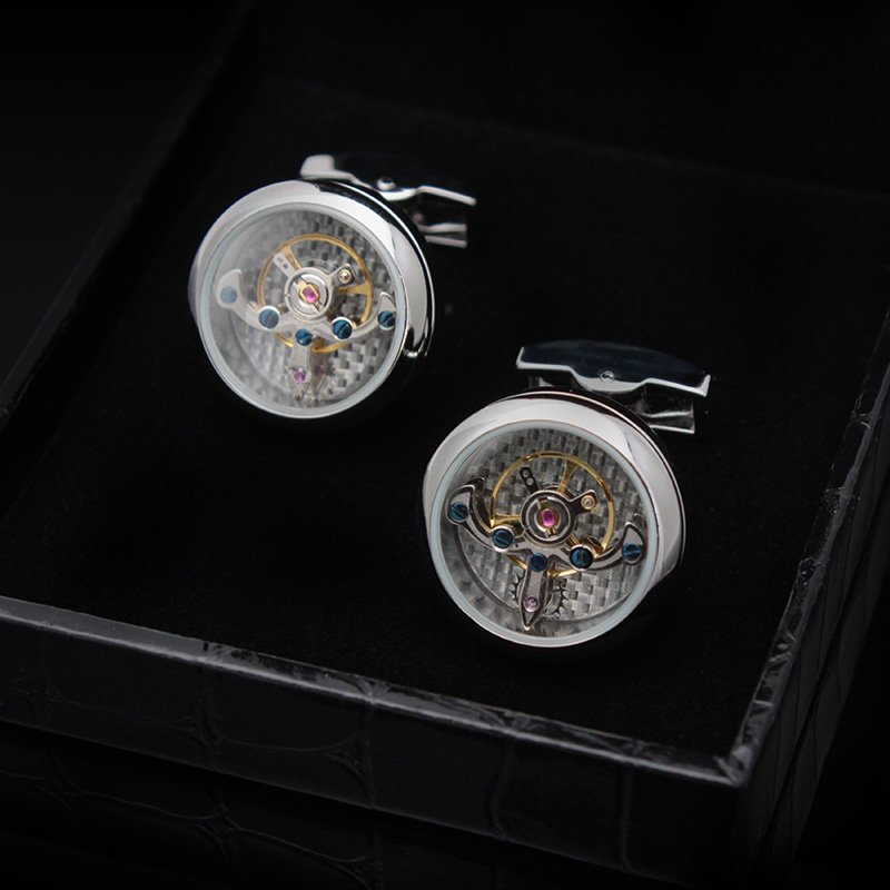 A pair of Automatic Watch Engine Cufflinks made from titanium, showcasing intricate watch mechanics, presented in an elegant gift box.