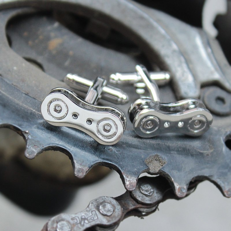 Stylish bike chain cufflinks made from titanium alloy, featuring a unique design perfect for french cuff shirts, presented in a luxurious gift box.