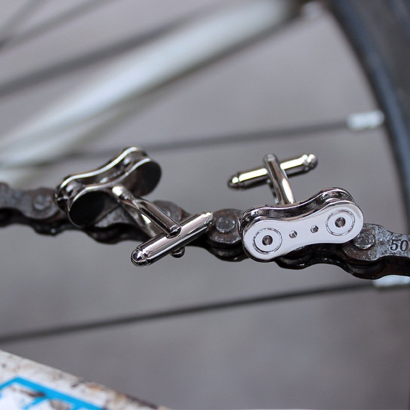 Stylish bike chain cufflinks made from titanium alloy, featuring a unique design perfect for french cuff shirts, presented in a luxurious gift box.