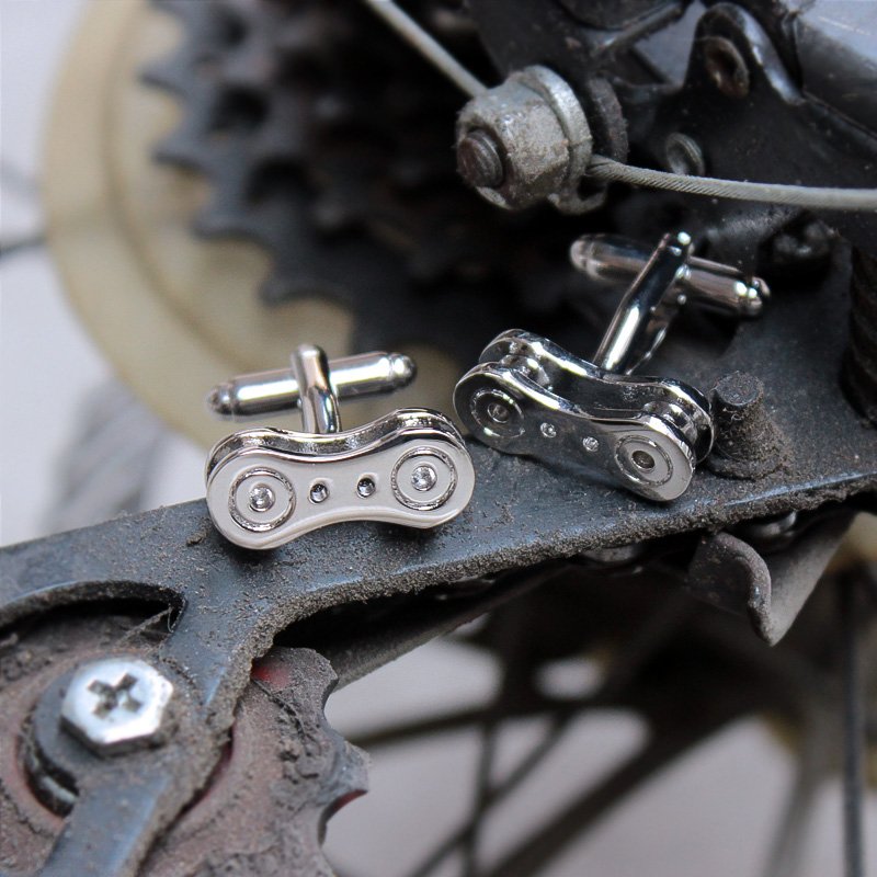 Stylish bike chain cufflinks made from titanium alloy, featuring a unique design perfect for french cuff shirts, presented in a luxurious gift box.