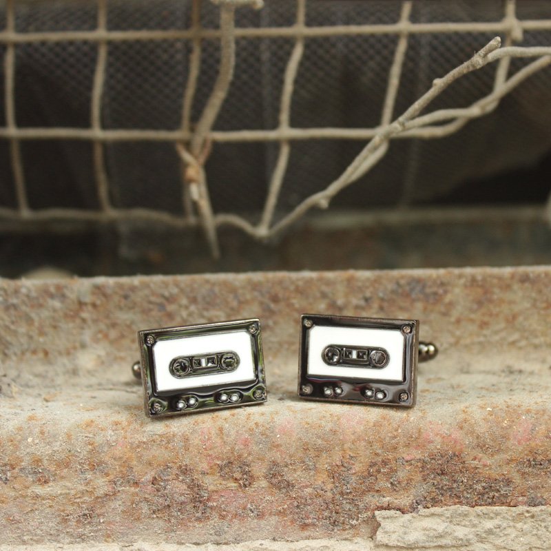 Stylish stainless steel cassette cufflinks with rhodium plating, featuring a unique cassette design, presented in a hard-sided gift box.