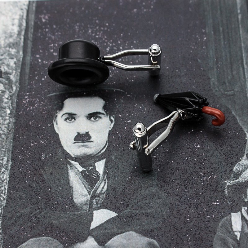 A pair of Chaplin's Hat & Umbrella Cufflinks made from titanium alloy, featuring a unique design inspired by Charlie Chaplin's iconic hat and umbrella.