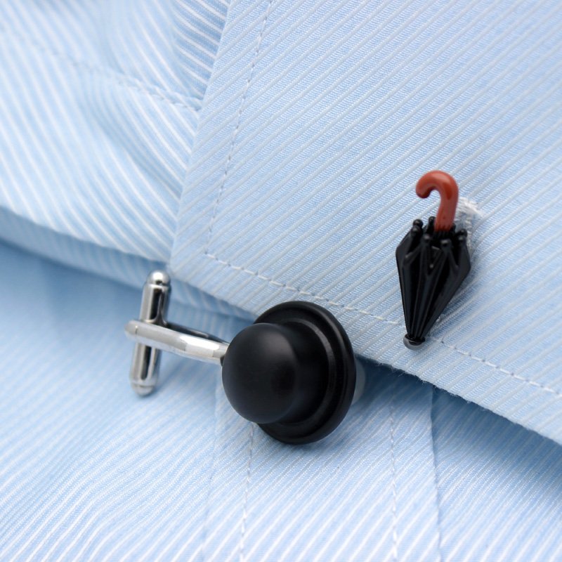 A pair of Chaplin's Hat & Umbrella Cufflinks made from titanium alloy, featuring a unique design inspired by Charlie Chaplin's iconic hat and umbrella.