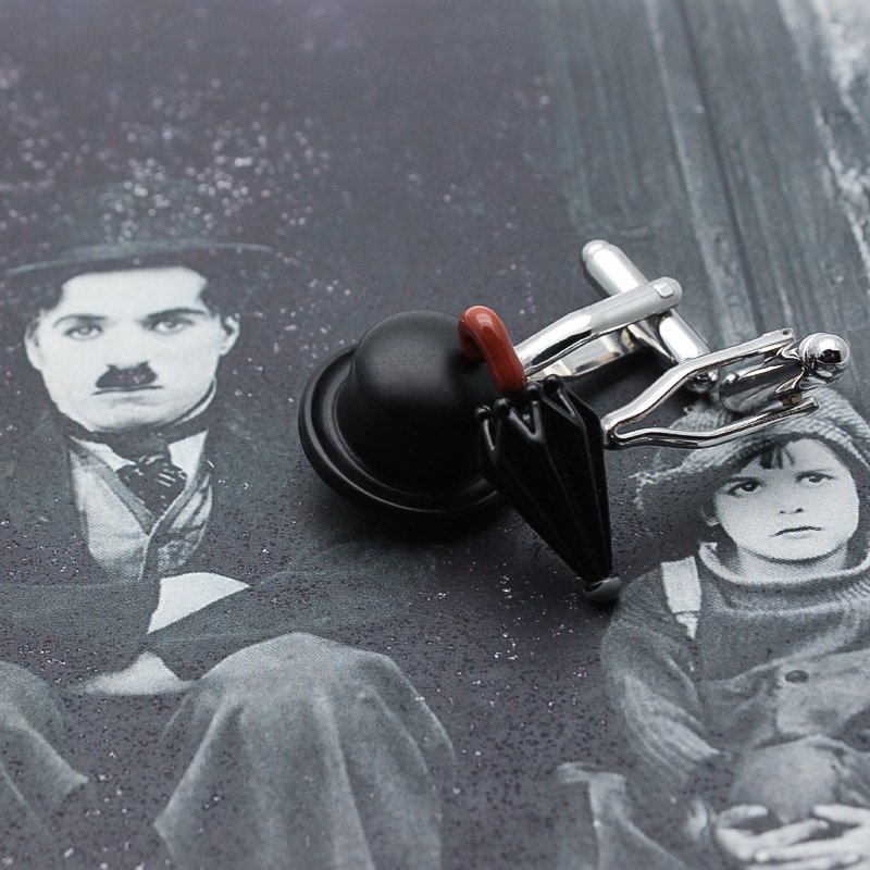 A pair of Chaplin's Hat & Umbrella Cufflinks made from titanium alloy, featuring a unique design inspired by Charlie Chaplin's iconic hat and umbrella.