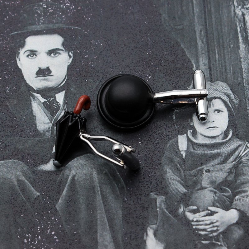 A pair of Chaplin's Hat & Umbrella Cufflinks made from titanium alloy, featuring a unique design inspired by Charlie Chaplin's iconic hat and umbrella.