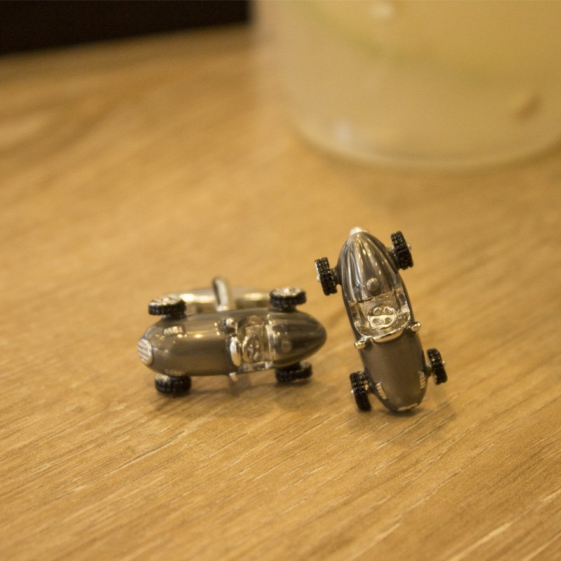 A pair of elegant stainless steel cufflinks featuring a unique classic car design, rhodium plated for a polished finish, displayed in a presentation box.