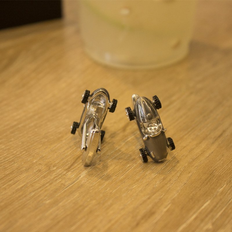 A pair of elegant stainless steel cufflinks featuring a unique classic car design, rhodium plated for a polished finish, displayed in a presentation box.