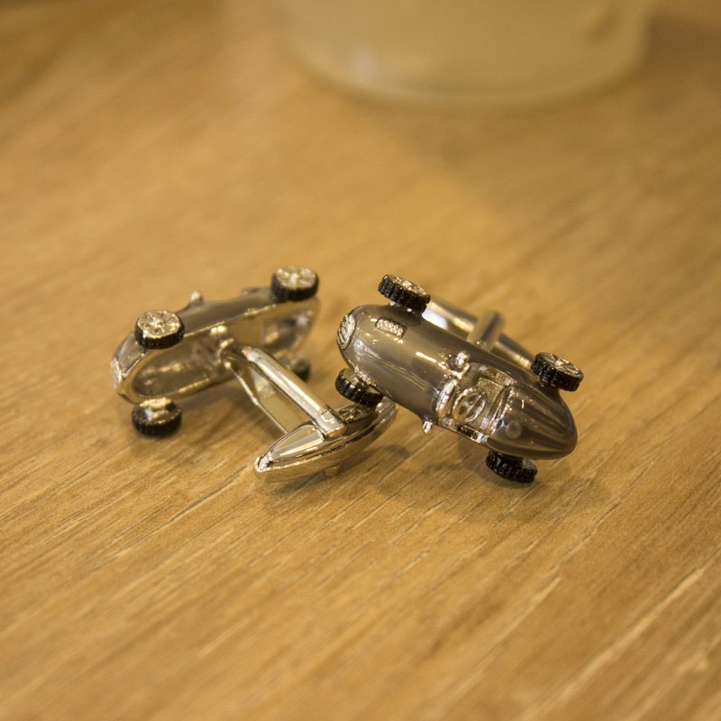 A pair of elegant stainless steel cufflinks featuring a unique classic car design, rhodium plated for a polished finish, displayed in a presentation box.