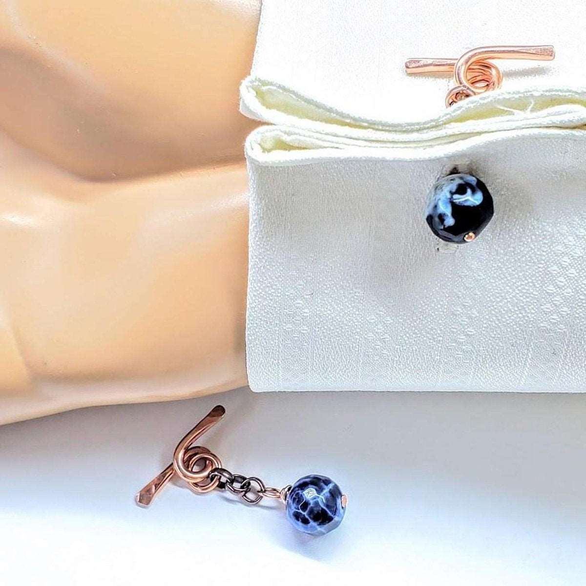 Handcrafted copper cufflinks featuring unique black blue crackle agate beads, symbolizing child abuse awareness with elegant rose gold hammered toggle.