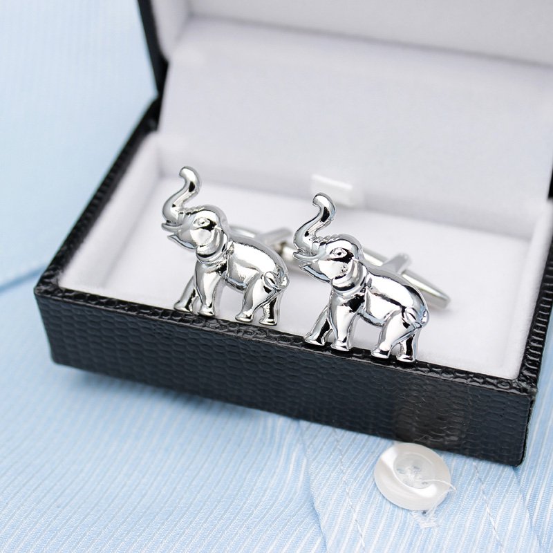 A pair of elegant elephant cufflinks made from titanium alloy, featuring a polished finish and intricate design, presented in a stylish gift box.