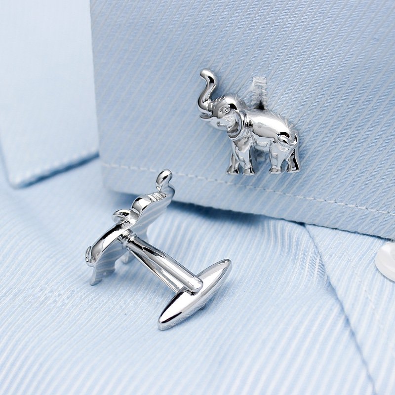 A pair of elegant elephant cufflinks made from titanium alloy, featuring a polished finish and intricate design, presented in a stylish gift box.