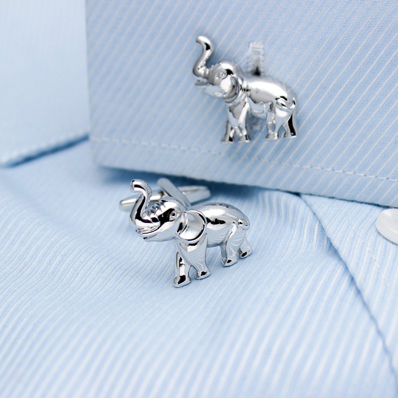 A pair of elegant elephant cufflinks made from titanium alloy, featuring a polished finish and intricate design, presented in a stylish gift box.