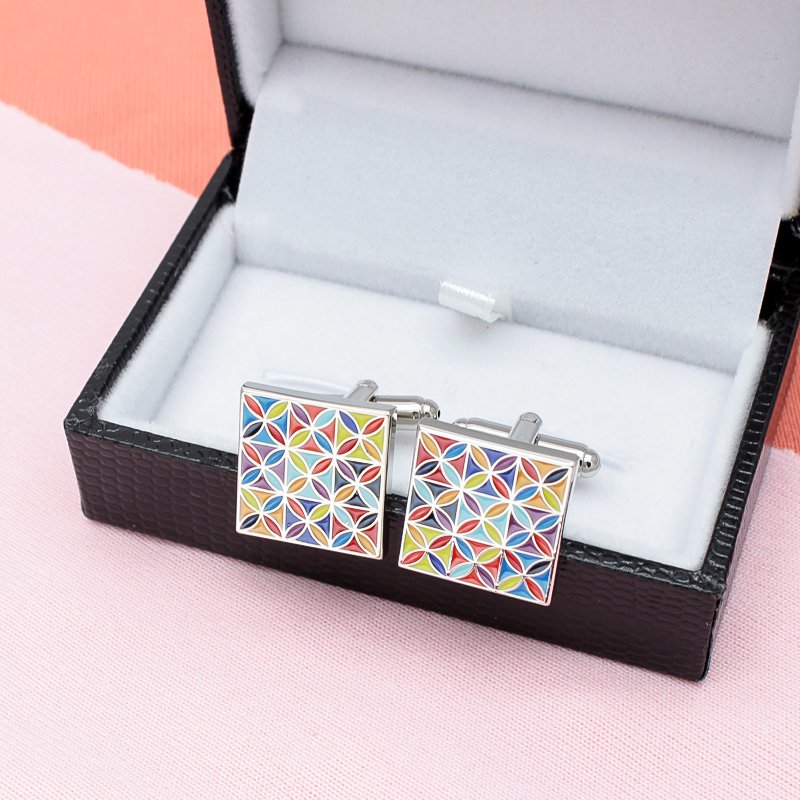 A pair of luxurious Enamel Art Cufflinks made from titanium alloy, featuring vibrant handcrafted enamel designs, presented in a stylish box.