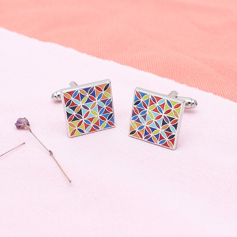 A pair of luxurious Enamel Art Cufflinks made from titanium alloy, featuring vibrant handcrafted enamel designs, presented in a stylish box.