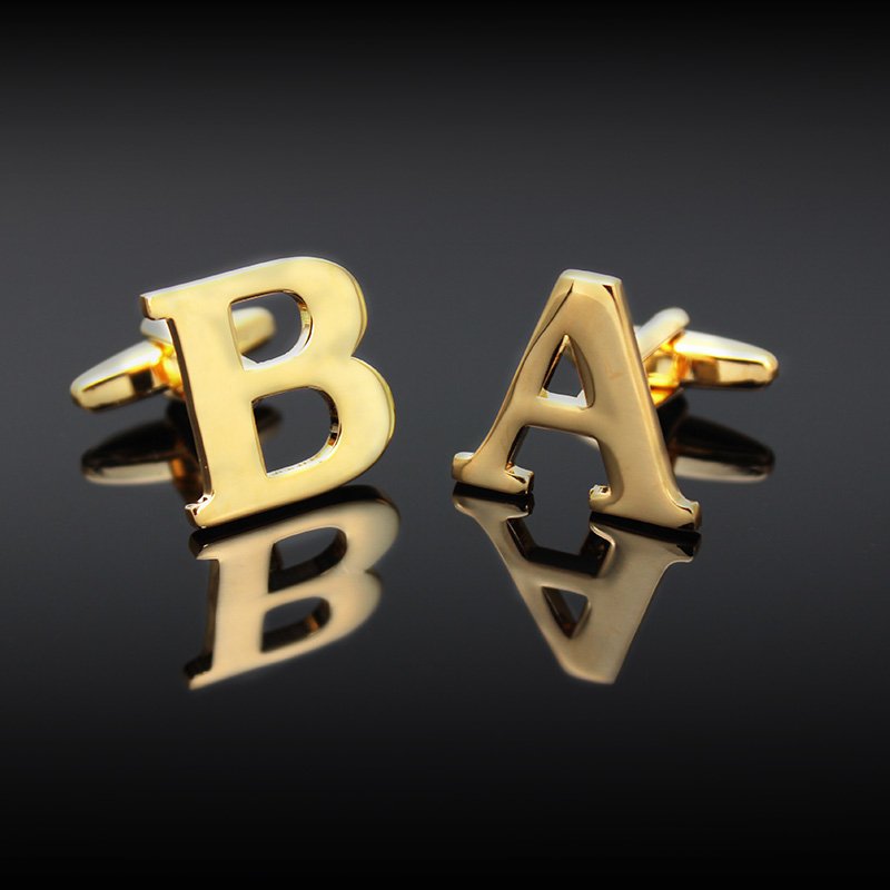 A pair of elegant golden cufflinks featuring capitalized alphabets, beautifully crafted from brass and gold plated, presented in a stylish gift box.