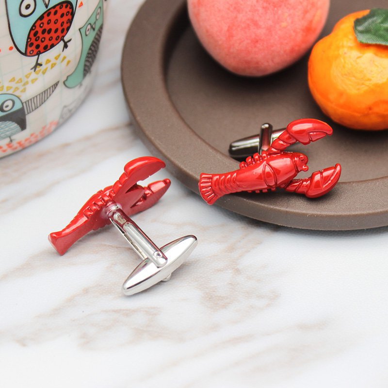 A pair of elegant lobster cufflinks made from titanium alloy, featuring a polished finish and unique lobster design, presented in a stylish box.