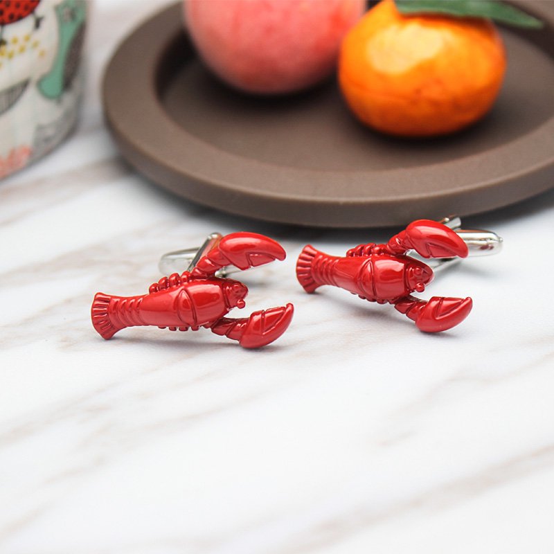 A pair of elegant lobster cufflinks made from titanium alloy, featuring a polished finish and unique lobster design, presented in a stylish box.