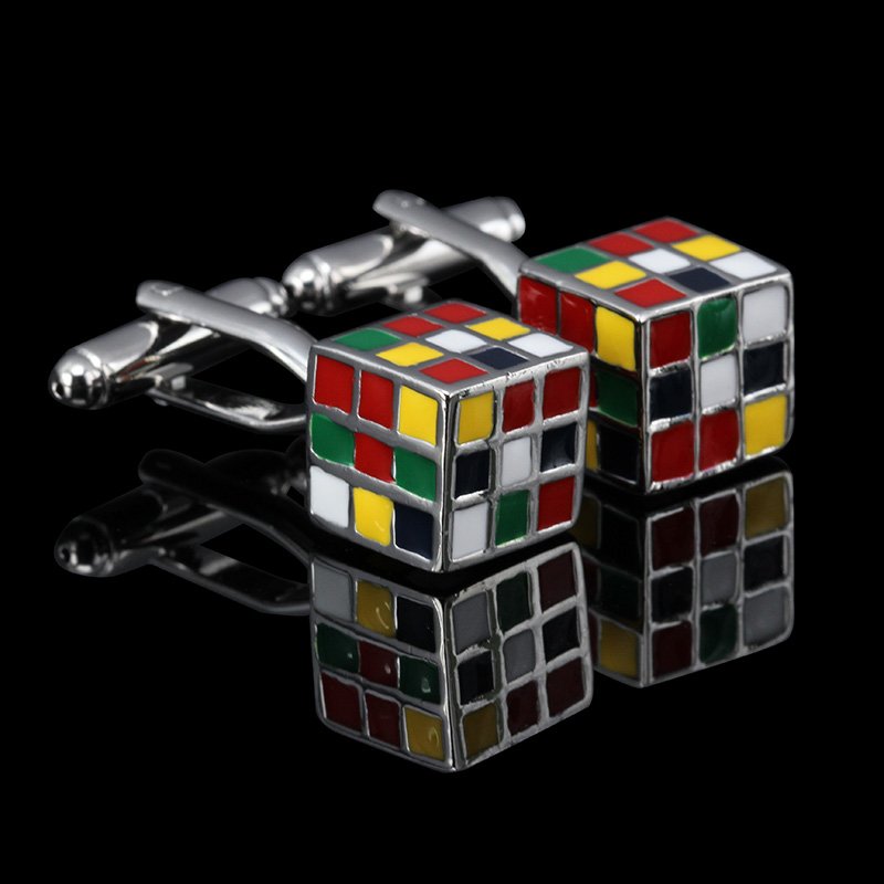 A pair of stylish Magic Cube Cufflinks made from brass and stainless steel, featuring a rhodium plated finish, displayed in an elegant presentation box.