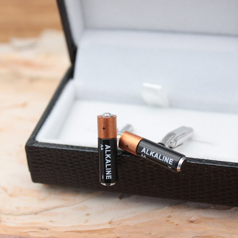 A pair of stylish Mini Battery Cufflinks made from titanium alloy, featuring a unique battery design, presented in a hard-sided gift box.