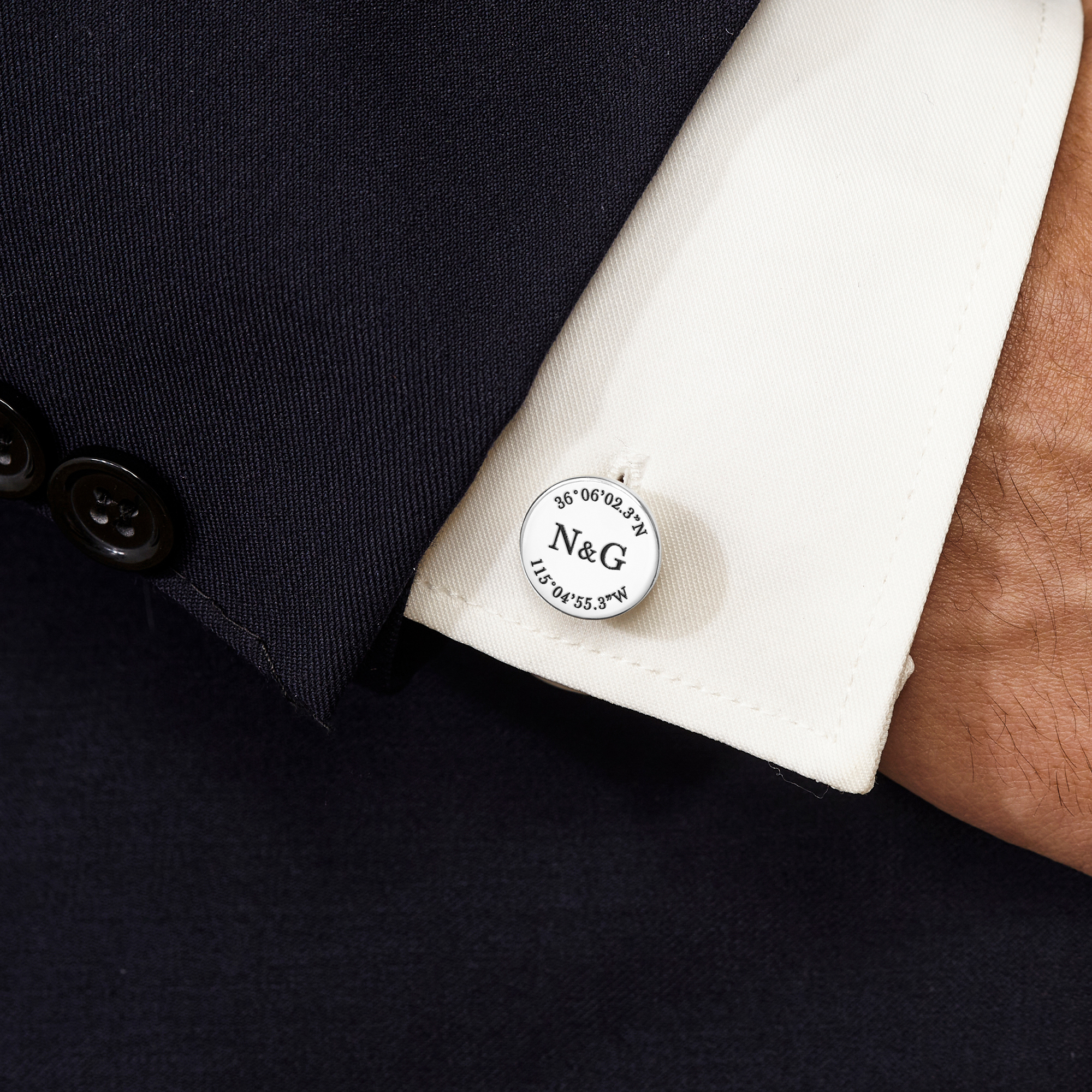 A pair of personalized groom cufflinks made from solid 925 sterling silver, engraved with custom coordinates and initials, elegantly displayed in a gift box.