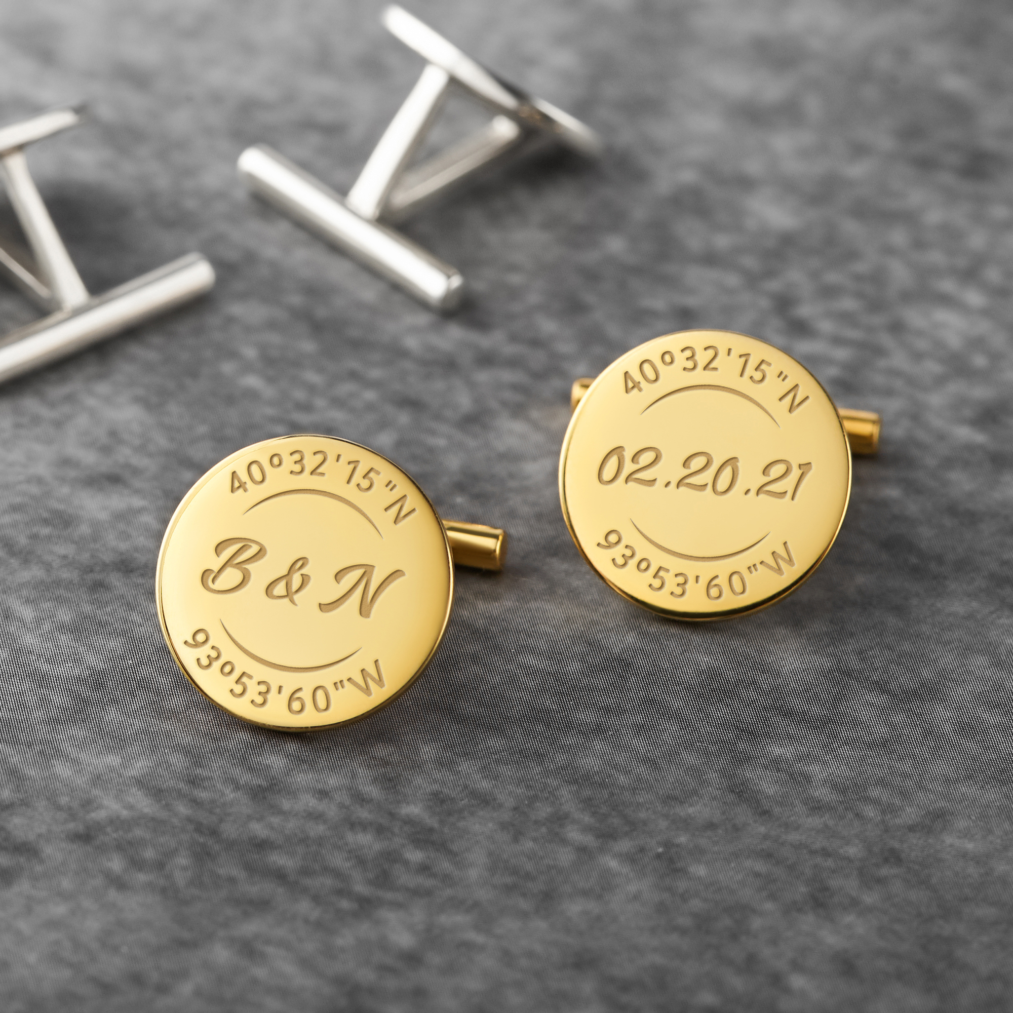 A pair of personalized groom cufflinks made from solid 925 sterling silver, engraved with custom coordinates and initials, elegantly displayed in a gift box.