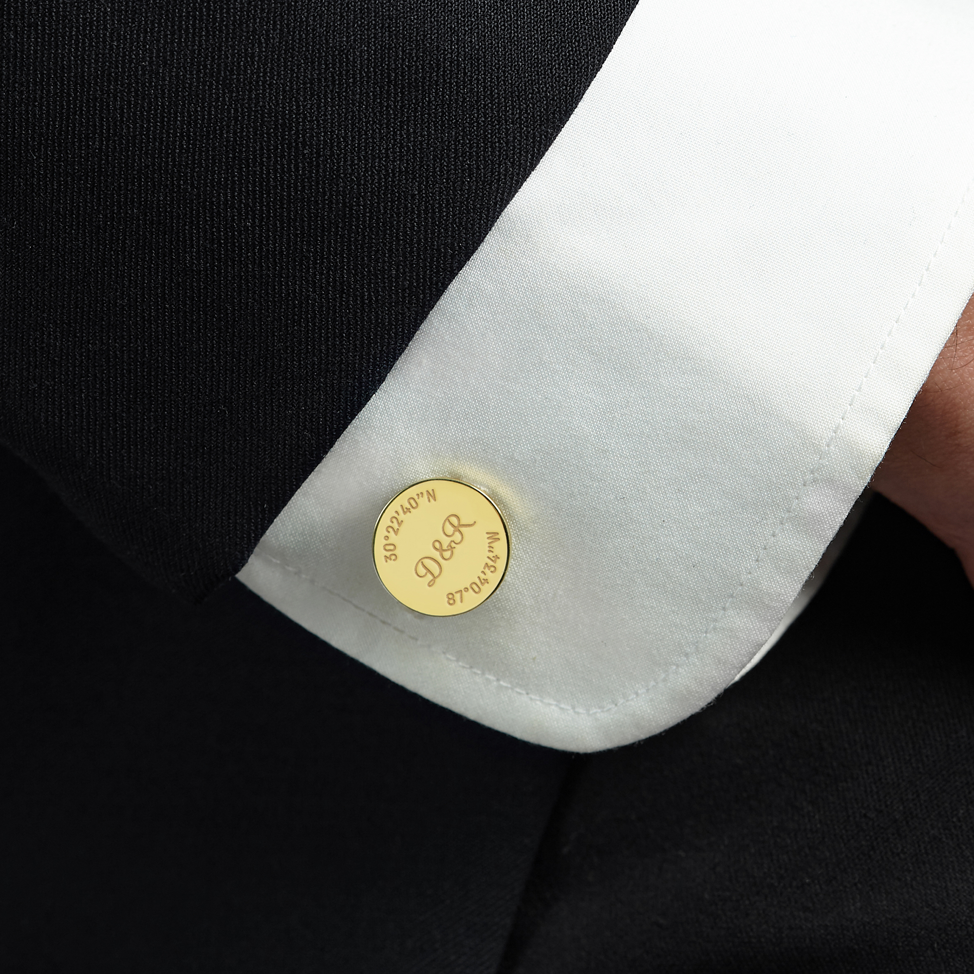 A pair of personalized groom cufflinks made from solid 925 sterling silver, engraved with custom coordinates and initials, elegantly displayed in a gift box.