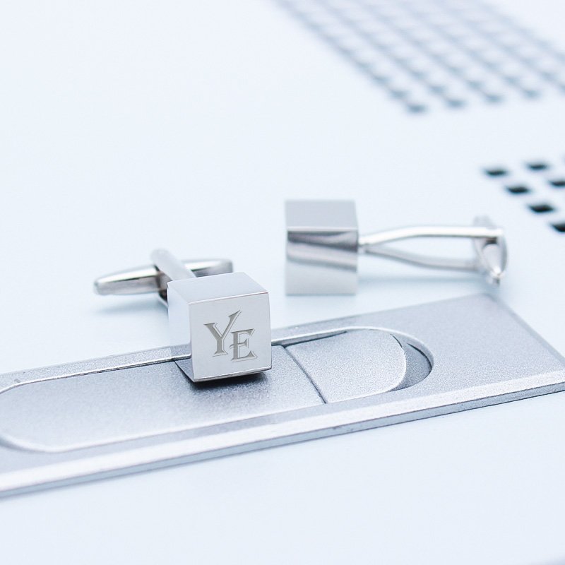 A pair of stylish Personalized Iron Cube Cufflinks made from titanium alloy, featuring a modern cube design, presented in a sleek gift box.