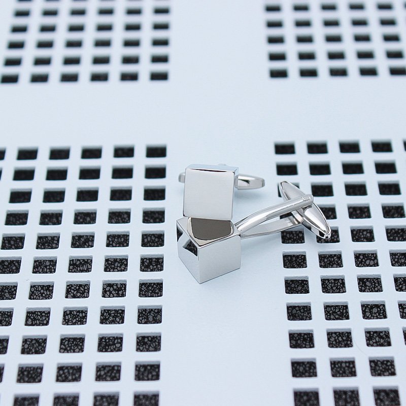 A pair of stylish Personalized Iron Cube Cufflinks made from titanium alloy, featuring a modern cube design, presented in a sleek gift box.