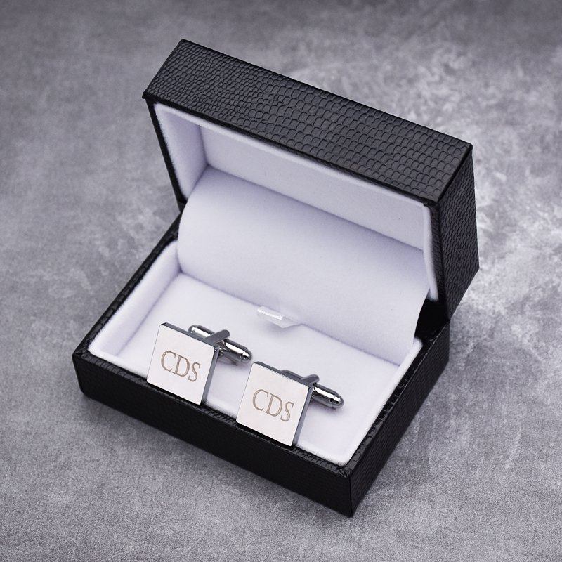 A pair of stylish Personalized Iron Slice Cufflinks made from titanium alloy, featuring a unique design, presented in an elegant hard-sided box.