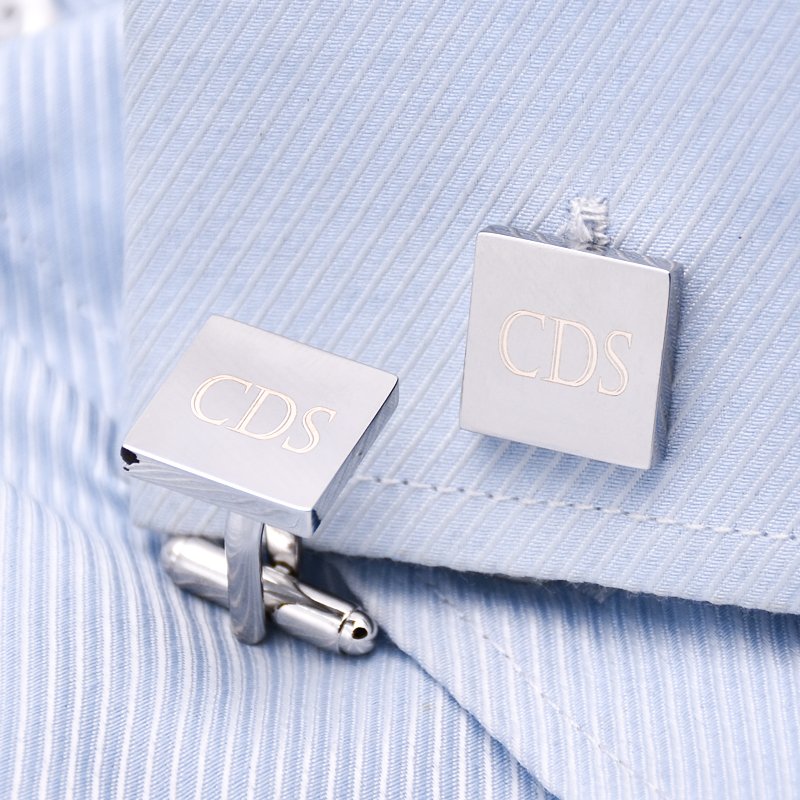 A pair of stylish Personalized Iron Slice Cufflinks made from titanium alloy, featuring a unique design, presented in an elegant hard-sided box.