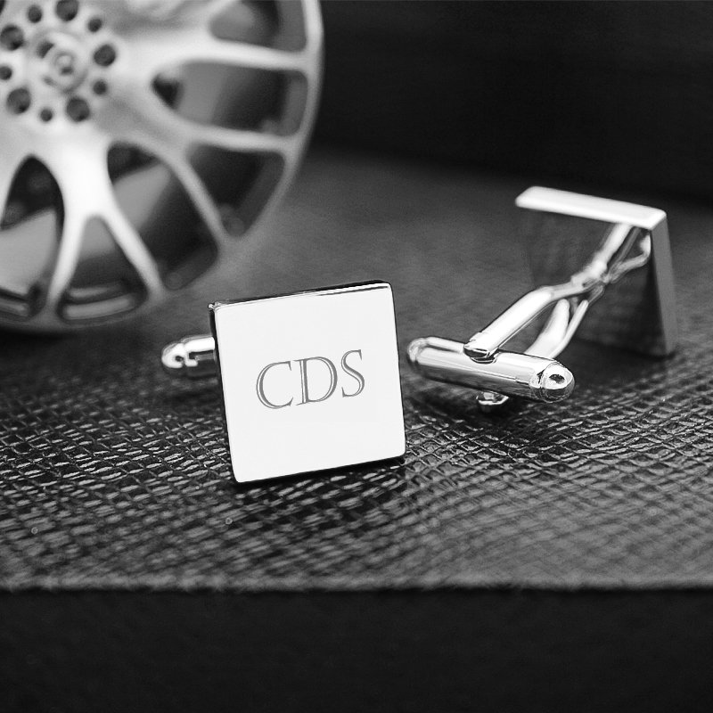 A pair of stylish Personalized Iron Slice Cufflinks made from titanium alloy, featuring a unique design, presented in an elegant hard-sided box.