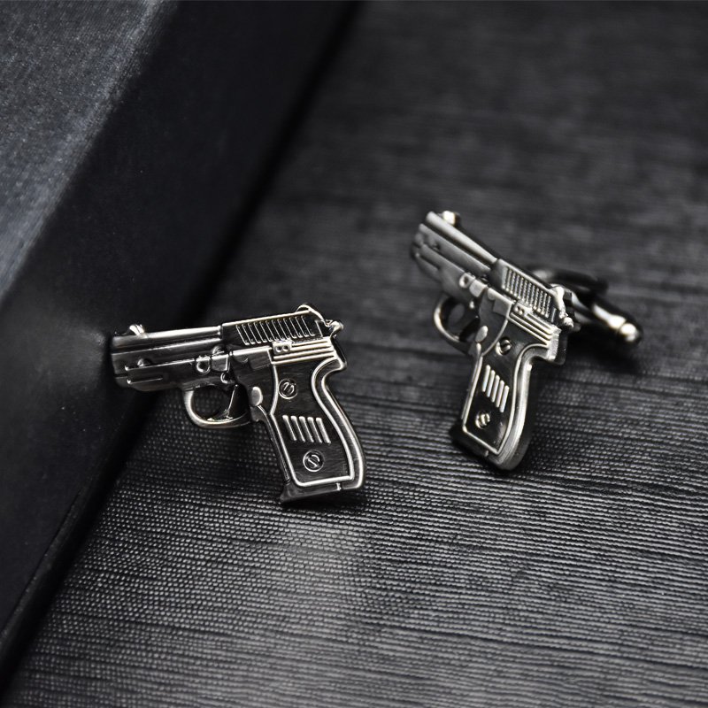 Stylish Pistol Cufflinks made from titanium alloy, featuring a unique design and luxurious finish, presented in an elegant gift box.