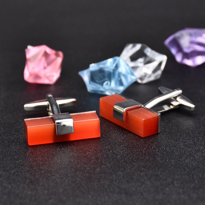 A pair of elegant Ruby Cufflinks made from titanium alloy with artificial ruby, displayed in a luxurious presentation box.