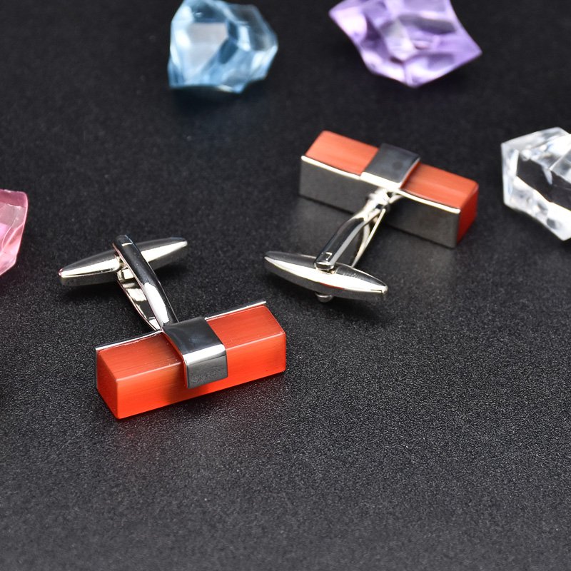 A pair of elegant Ruby Cufflinks made from titanium alloy with artificial ruby, displayed in a luxurious presentation box.