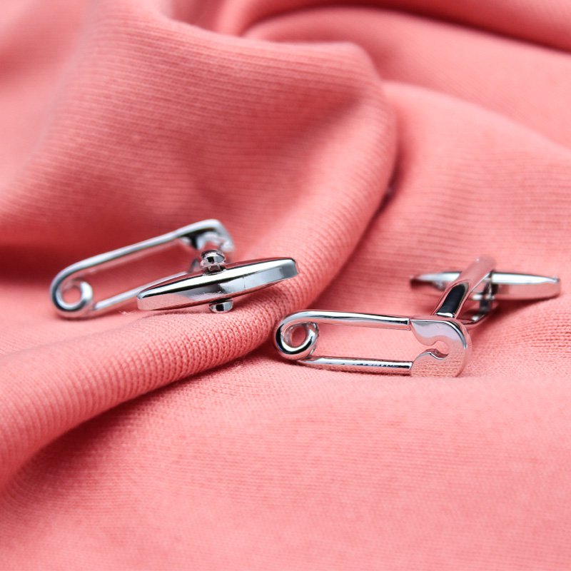 A pair of stylish Safety Pin Cufflinks made from titanium alloy, featuring a unique design with a luxury surface finish, presented in a hard-sided box.