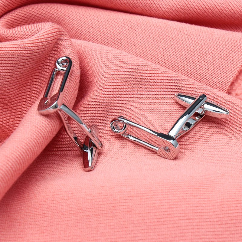 A pair of stylish Safety Pin Cufflinks made from titanium alloy, featuring a unique design with a luxury surface finish, presented in a hard-sided box.