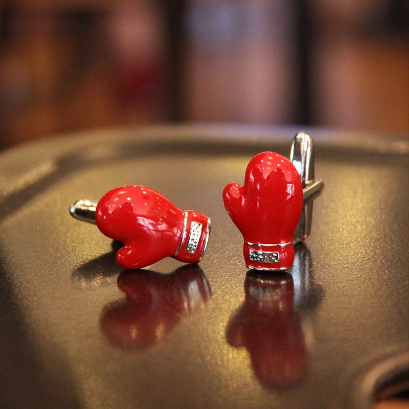 A pair of festive Santa Claus cufflinks featuring red gloves, made of stainless steel and rhodium plated, presented in a stylish gift box.