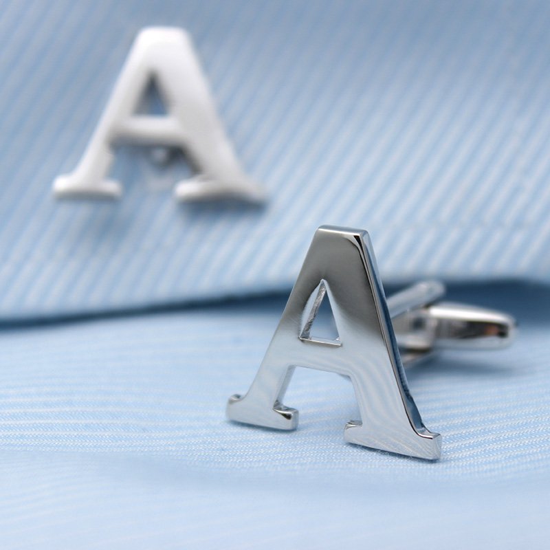 A pair of elegant silver alphabets cufflinks featuring capitalized letters, crafted from brass and chrome plated, presented in a stylish gift box.