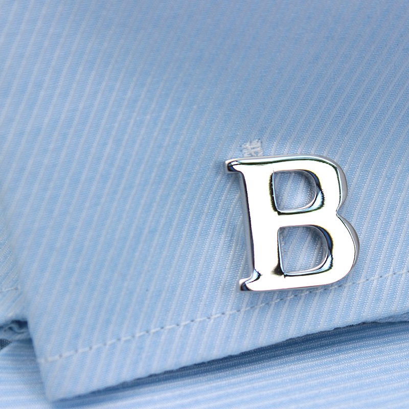 A pair of elegant silver alphabets cufflinks featuring capitalized letters, crafted from brass and chrome plated, presented in a stylish gift box.