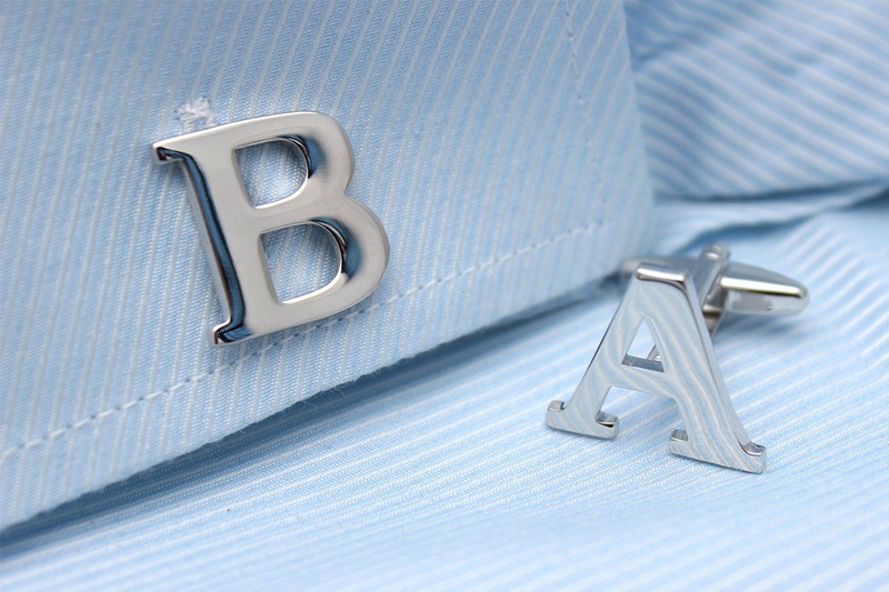 A pair of elegant silver alphabets cufflinks featuring capitalized letters, crafted from brass and chrome plated, presented in a stylish gift box.