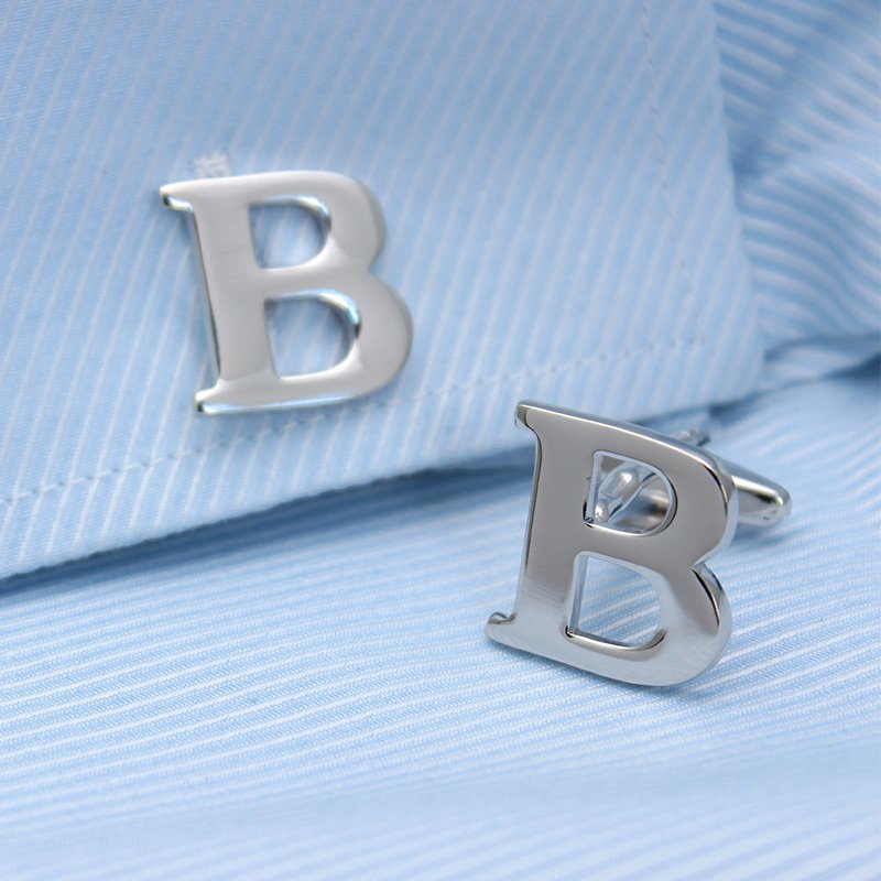 A pair of elegant silver alphabets cufflinks featuring capitalized letters, crafted from brass and chrome plated, presented in a stylish gift box.