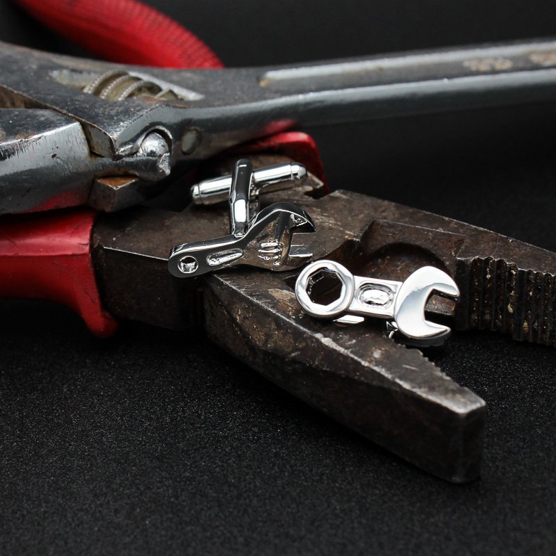 A pair of elegant Spanner Cufflinks made from titanium alloy, featuring a sleek design and perfect plating finish, displayed in a hard-sided presentation box.