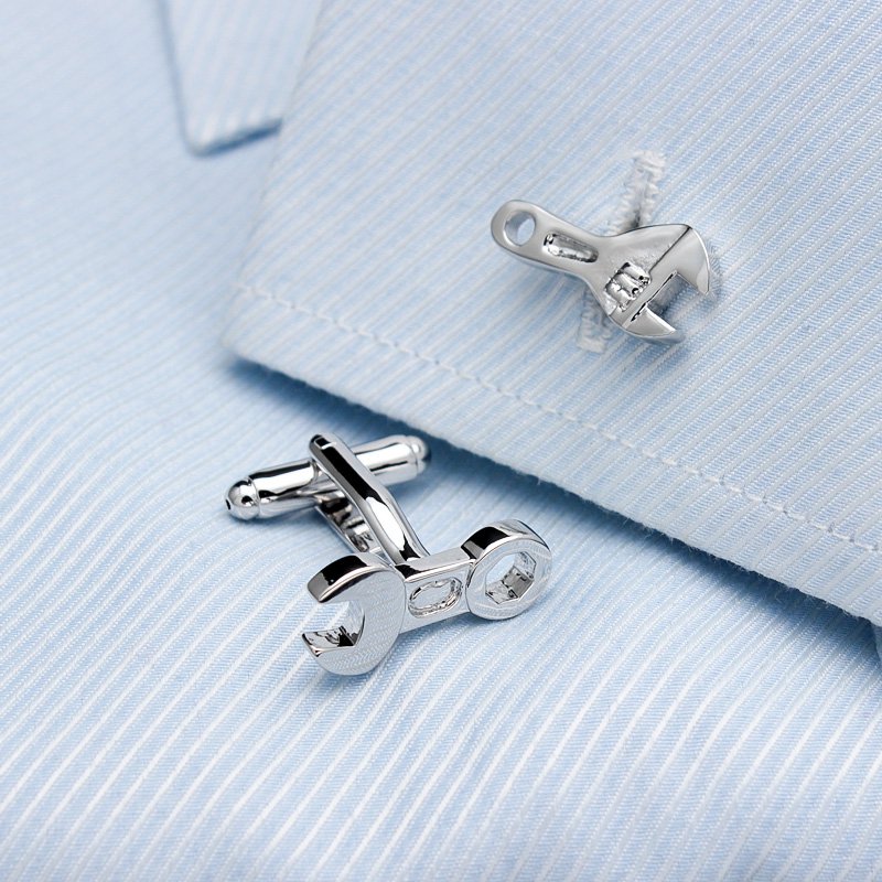 A pair of elegant Spanner Cufflinks made from titanium alloy, featuring a sleek design and perfect plating finish, displayed in a hard-sided presentation box.