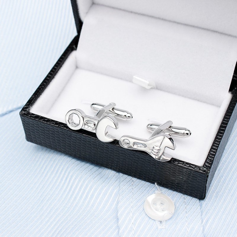 A pair of elegant Spanner Cufflinks made from titanium alloy, featuring a sleek design and perfect plating finish, displayed in a hard-sided presentation box.